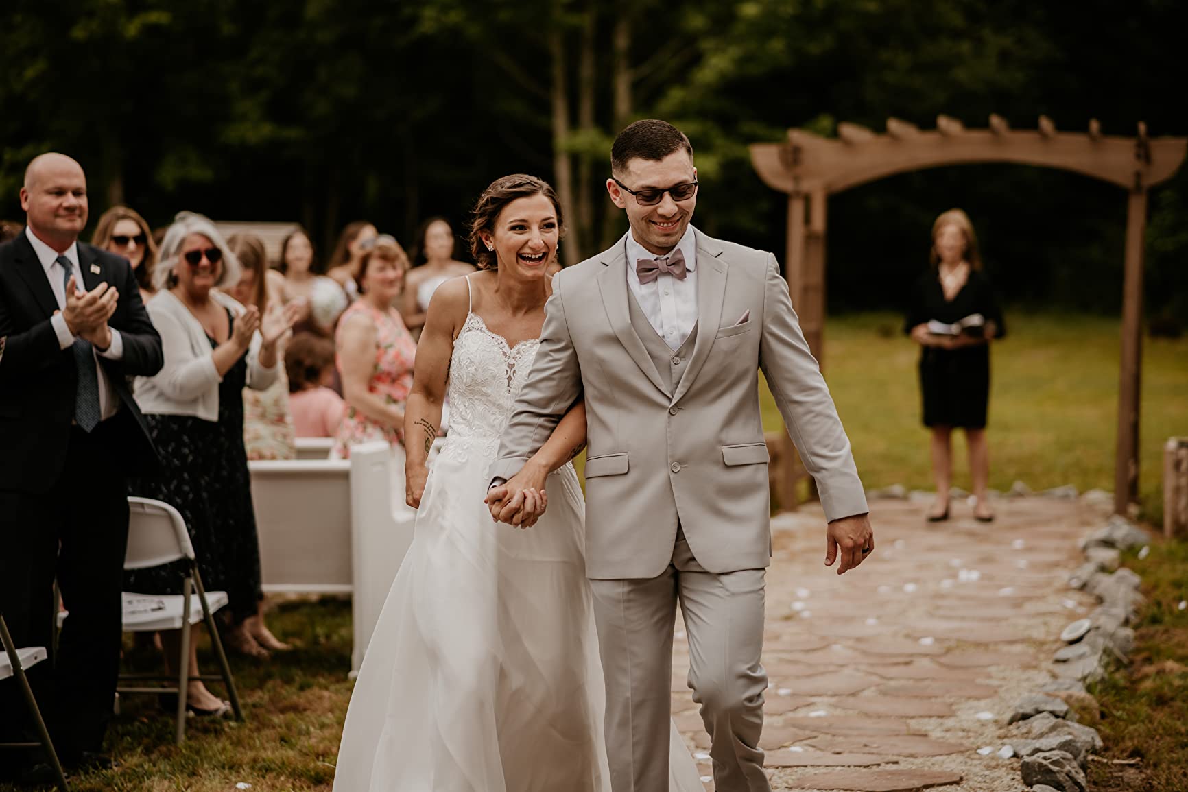 Newlyweds walking together after an outdoor ceremony